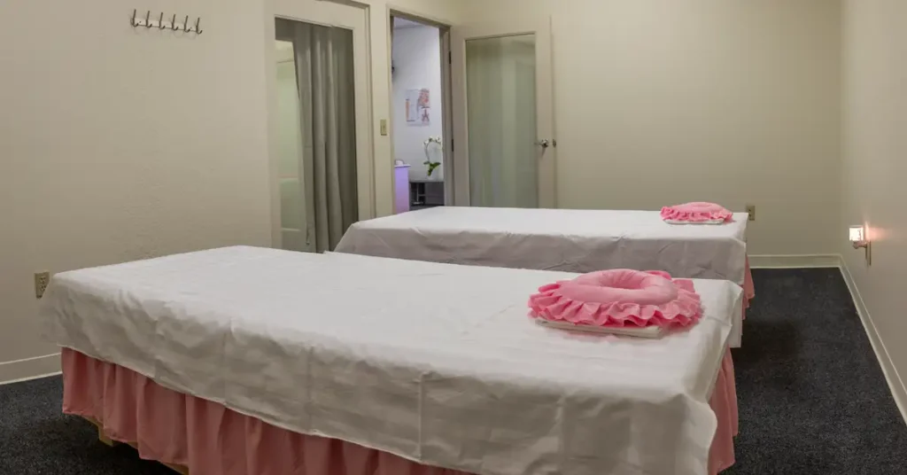 Peaceful couples massage room at Reno Massage Tree in Reno, Nevada prepared for two with soft lighting and fresh linens