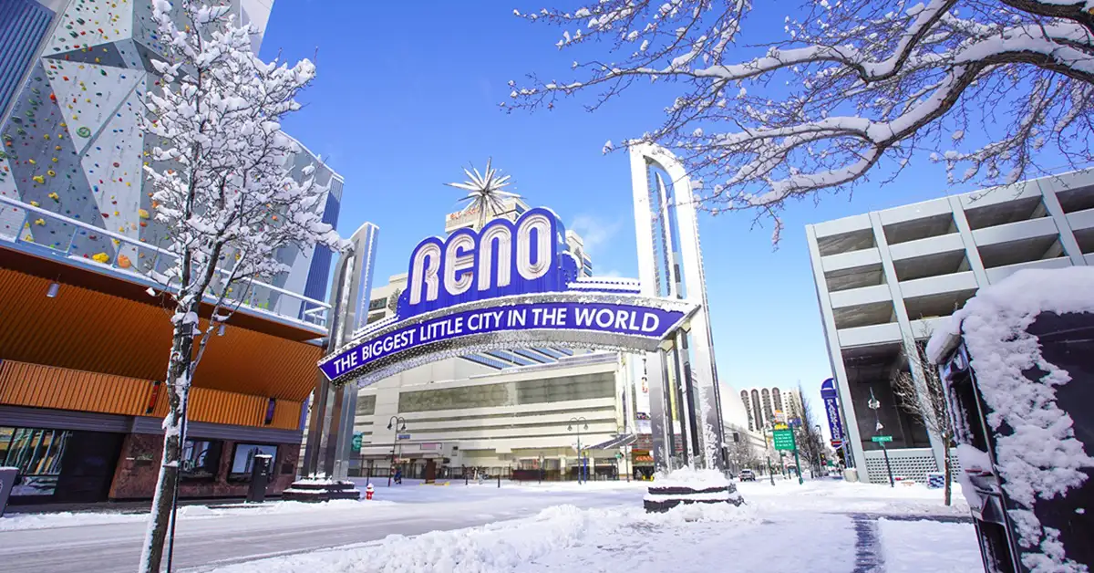 Massage and wellness in Reno NV with the downtown Reno arch surrounded by fresh winter snow