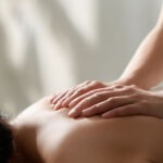 Therapist performing a relaxing massage on a client’s back at Reno Massage Tree