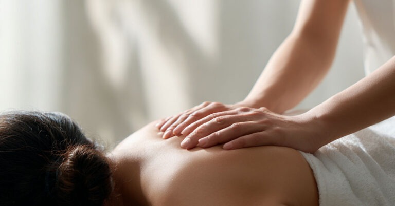 Therapist performing a relaxing massage on a client’s back at Reno Massage Tree