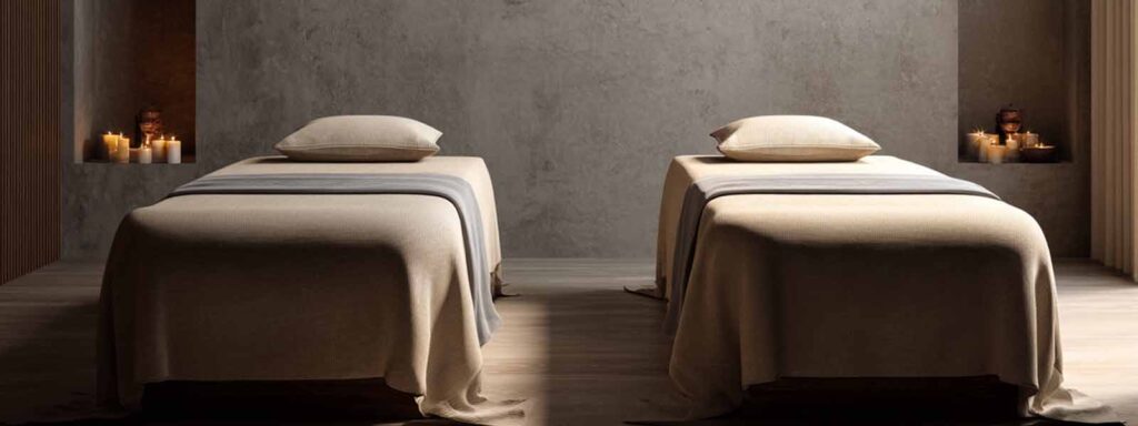 Two massage tables with candles in a calm spa room prepared for couples massage in Reno
